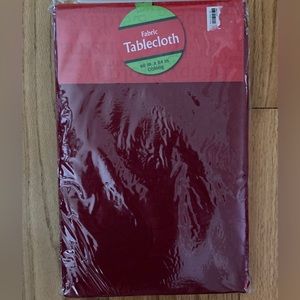 Red fabric tablecloth, New in Package. 60” x 84”, serving 6-8.